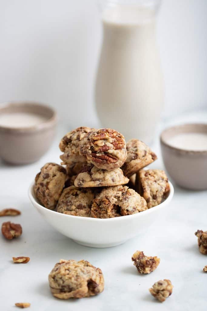 Dairy-Free Chocolate Chip Pecan Cookies filling a white bowl.