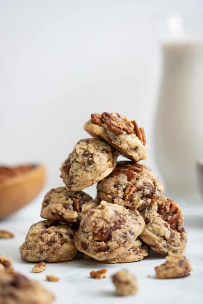 Pile of Dairy-Free Chocolate Chip Pecan Cookies on a marble countertop.