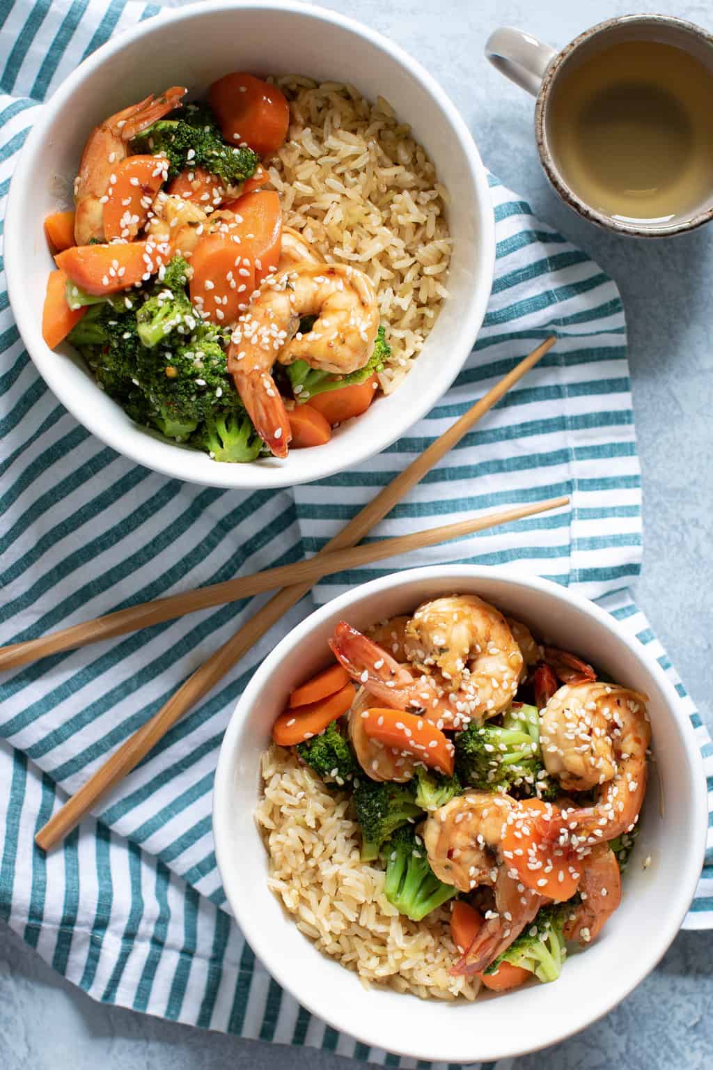 Two bowls of Healthy Honey Garlic Shrimp and Broccoli.