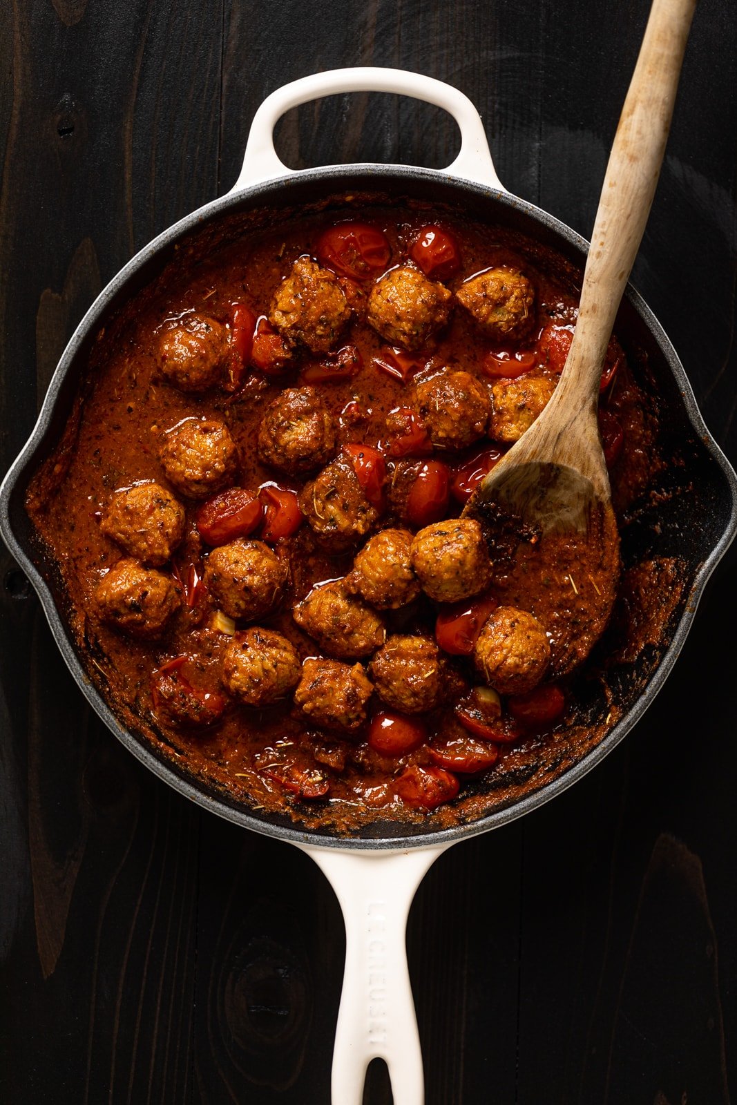 Vegan meatballs and sauce in a skillet