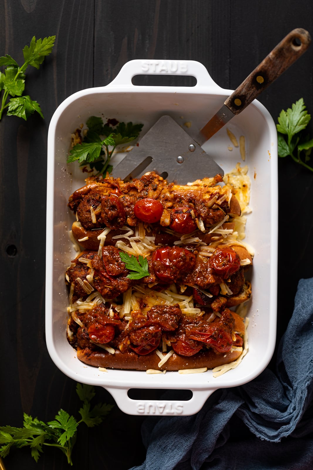 Pan of Vegan Meatball Subs with a serving spatula