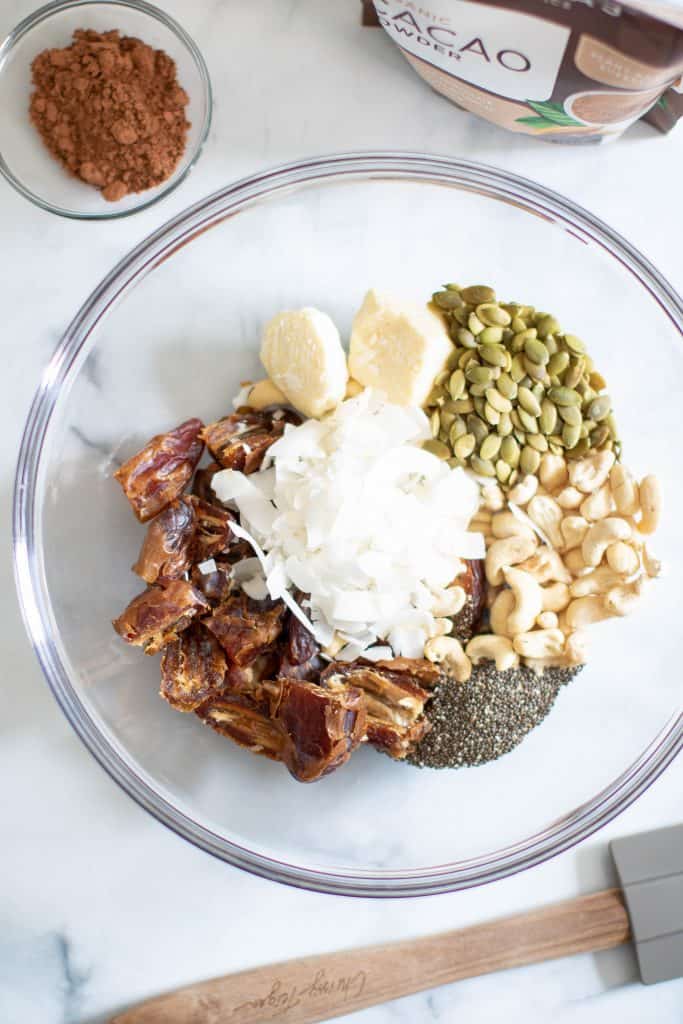 Bowl of ingredients including chia seeds, coconut flakes, and pumpkin seeds.