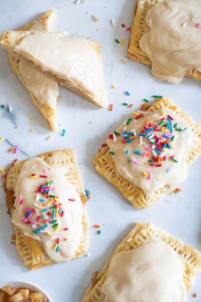 Homemade Vegan Apple-Cinnamon Pop Tarts on a white surface.