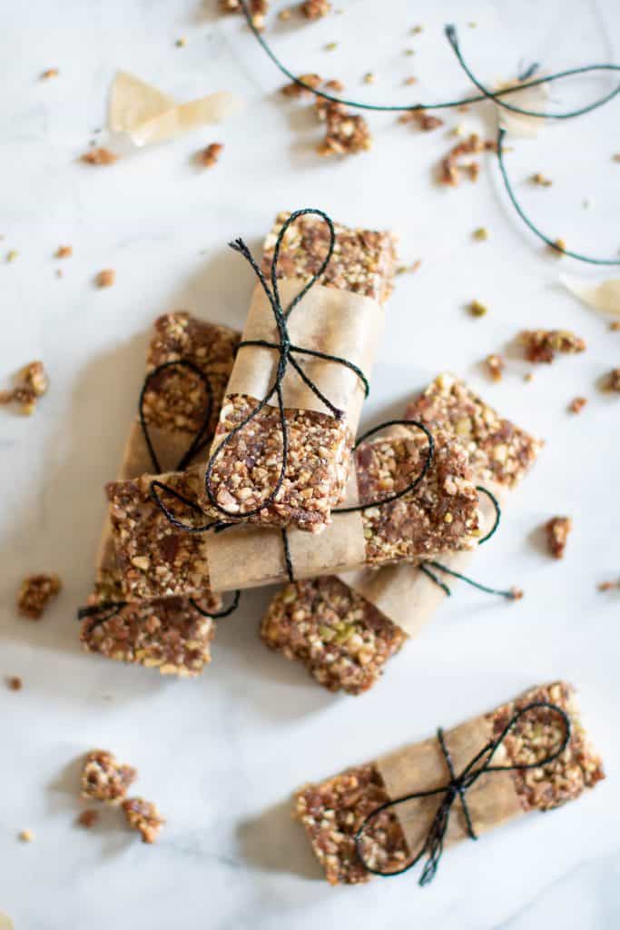 Pile of No-Bake Cacao Date Loaded Energy Bars.