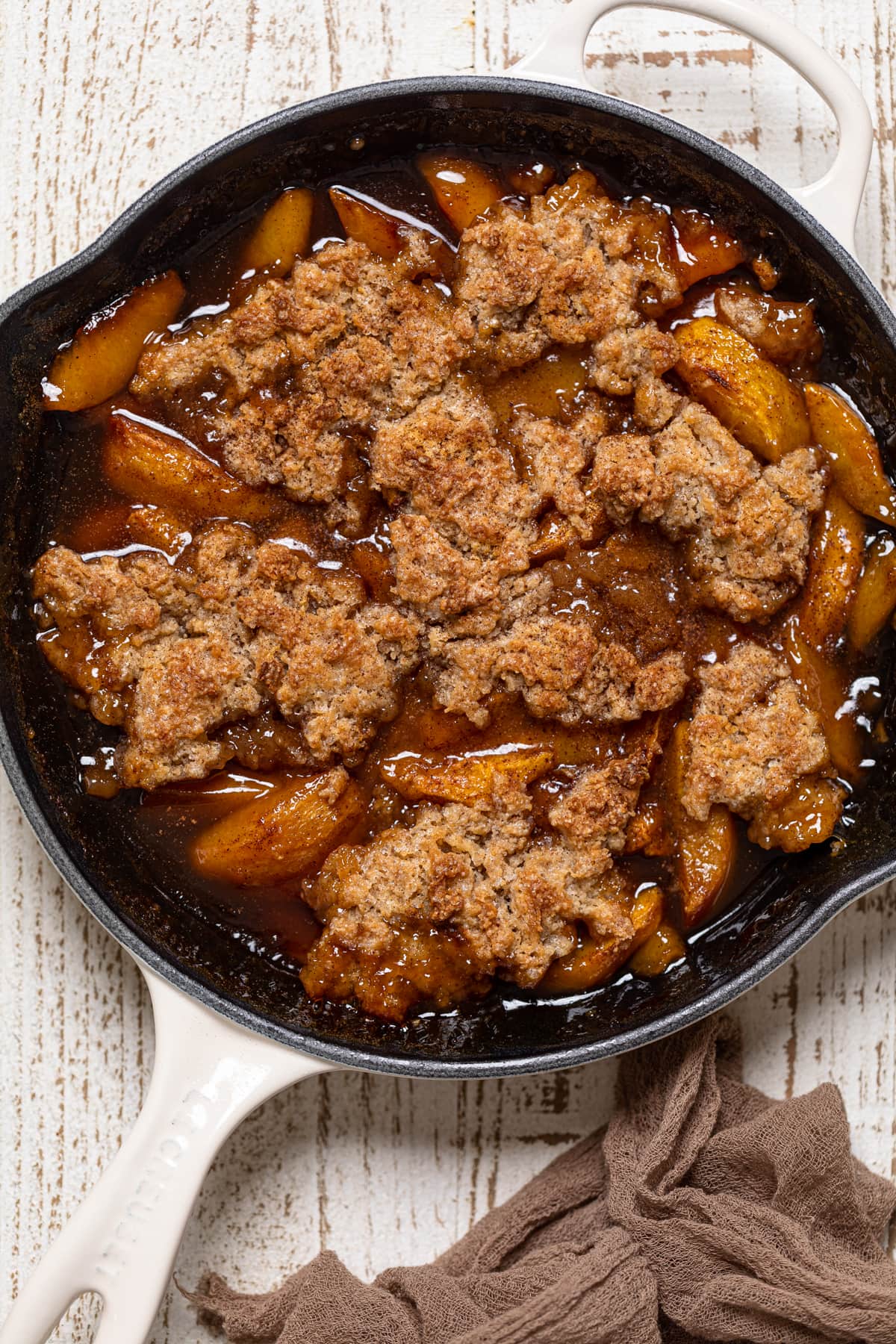 White skillet of Vegan Southern Peach Cobbler.