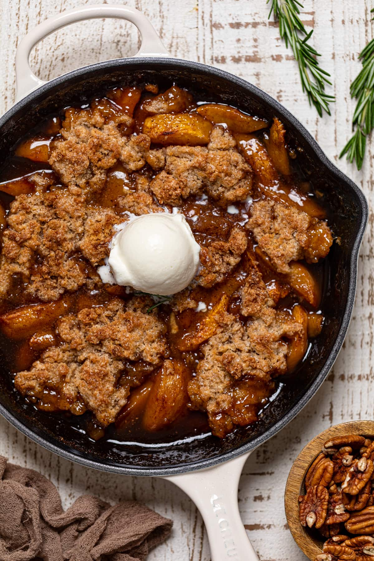 Dairy-free ice cream on a Vegan Southern Peach Cobbler.