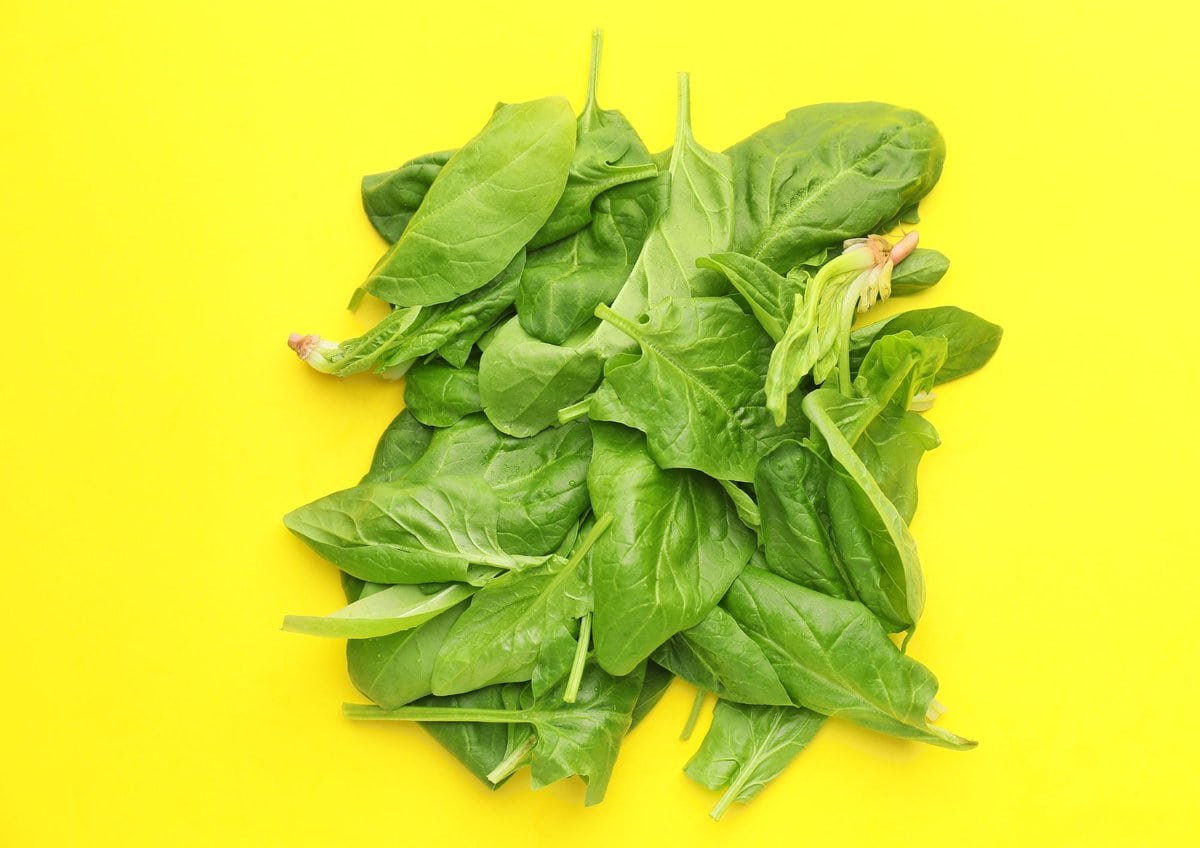 Spinach on yellow background.