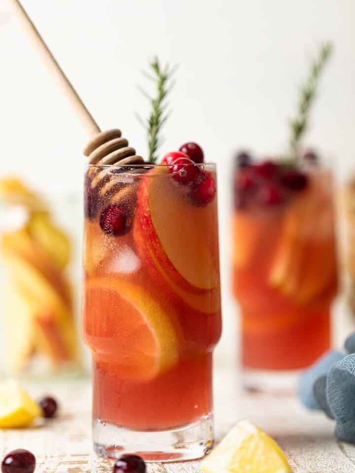 Tall glasses of Apple Cranberry Ginger Lemon Detox Juice.