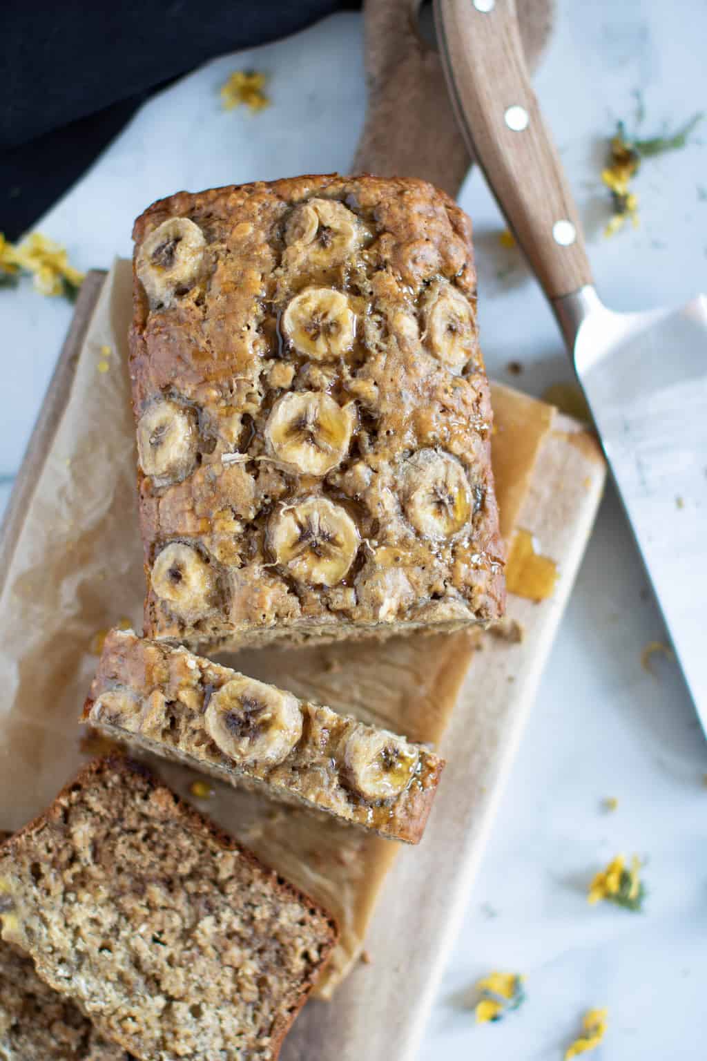 Partially-sliced loaf of Vegan Chia Seed Maple Banana Bread.