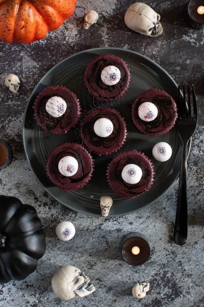 Halloween Graveyard Cheesecake Bites on a dark plate.