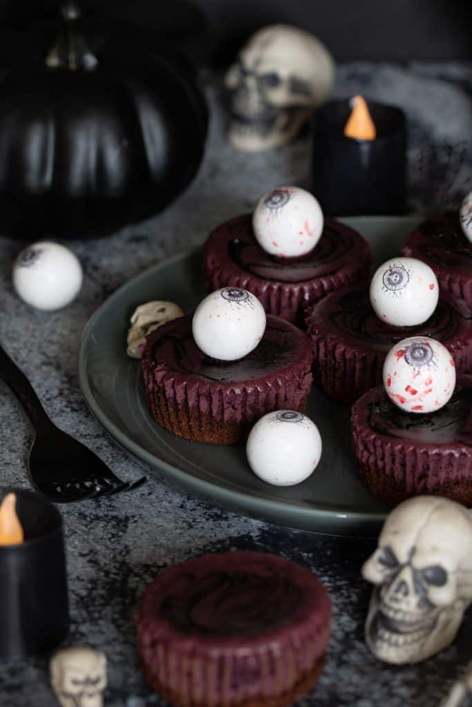 Halloween Graveyard Cheesecake Bites topped with eyeballs.