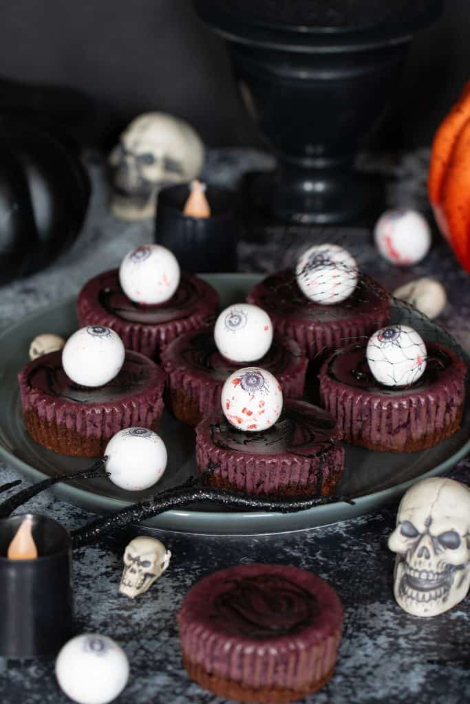 Halloween Graveyard Cheesecake Bites topped with eyeballs.