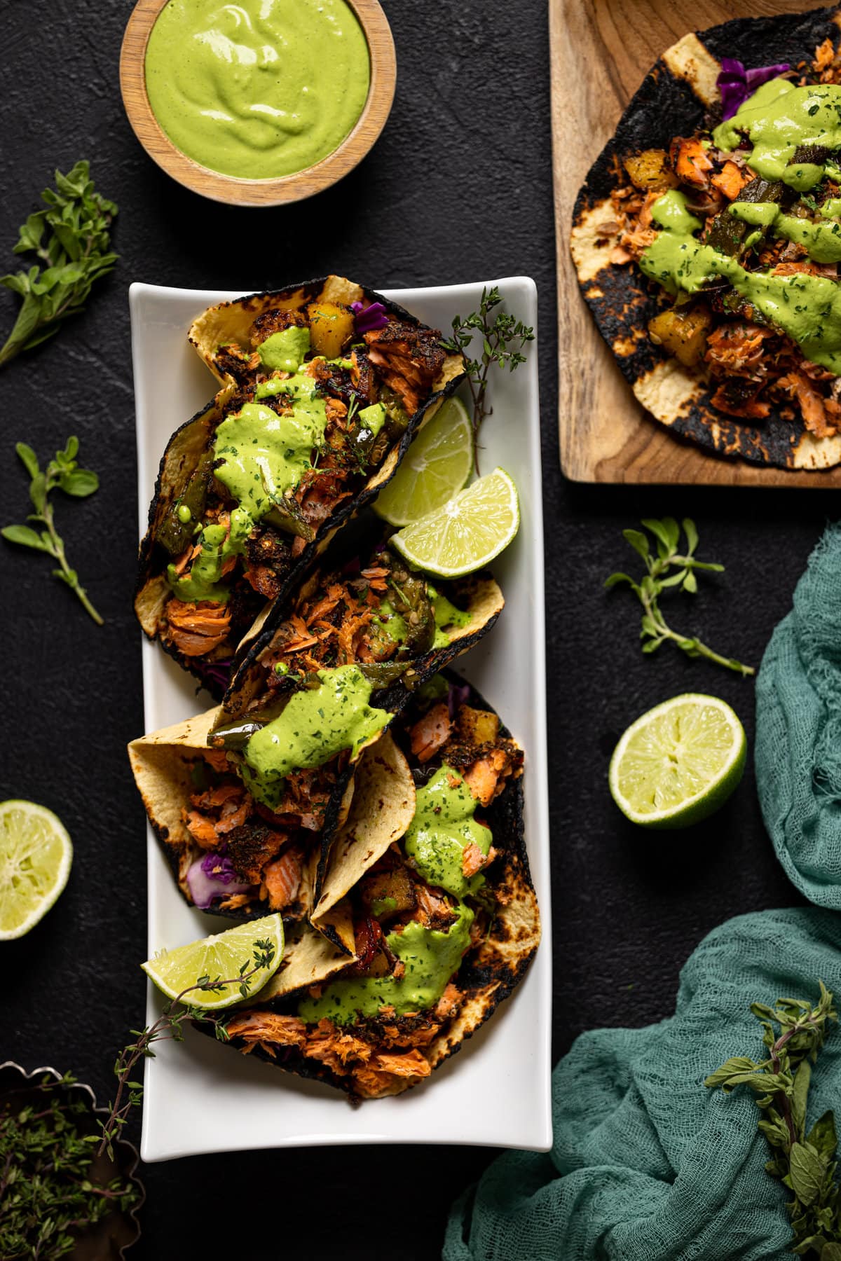 Overhead shot of a plate of Jerk Salmon Tacos with Avocado Cilantro Lime Sauce