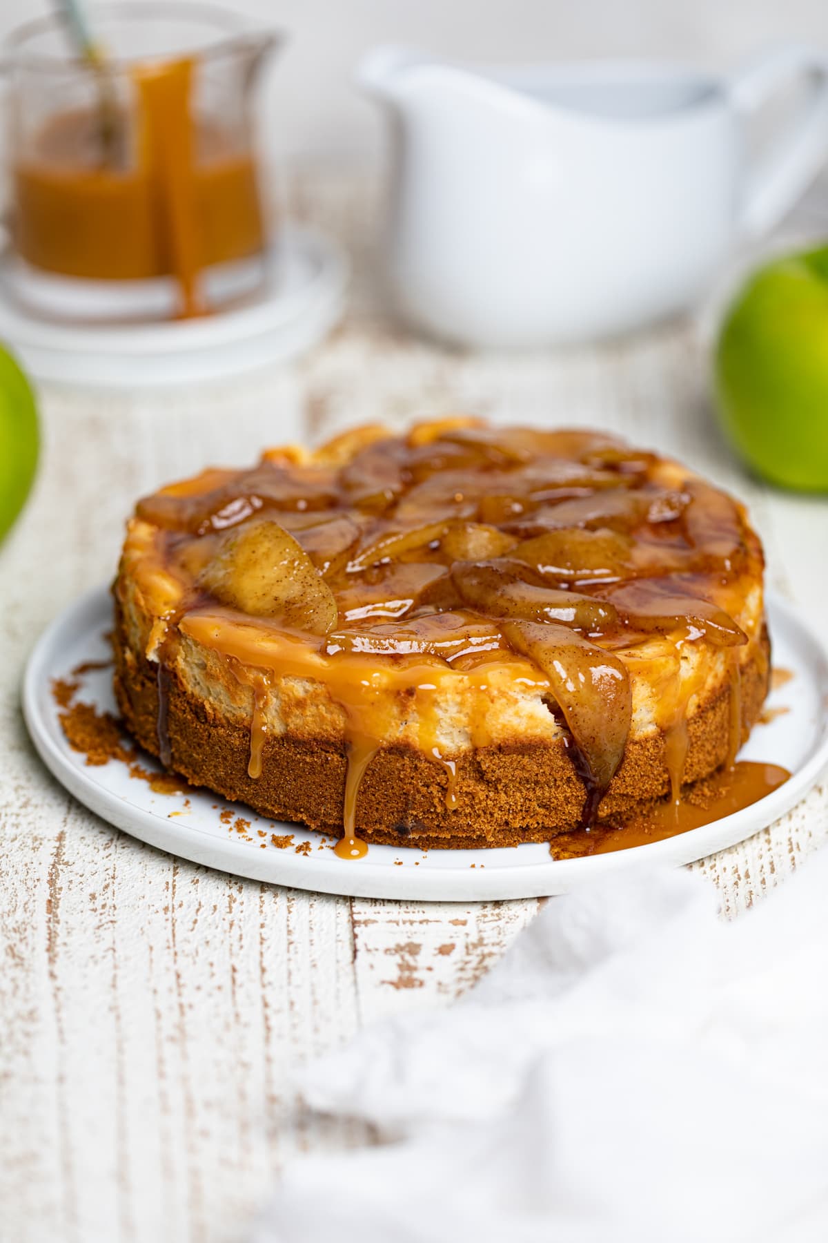 Caramel Apple Spice Cheesecake on a white plate.