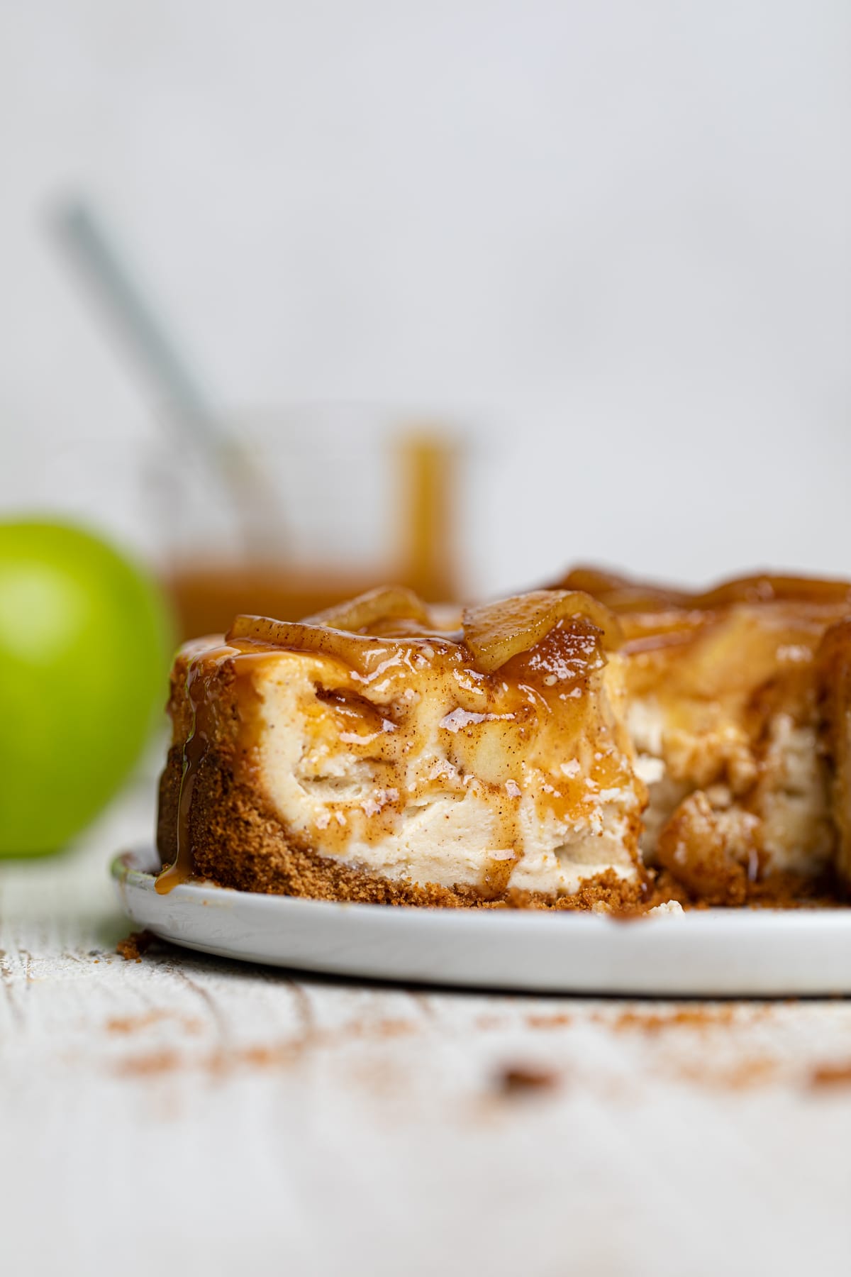 Slice being removed from a Caramel Apple Spice Cheesecake.