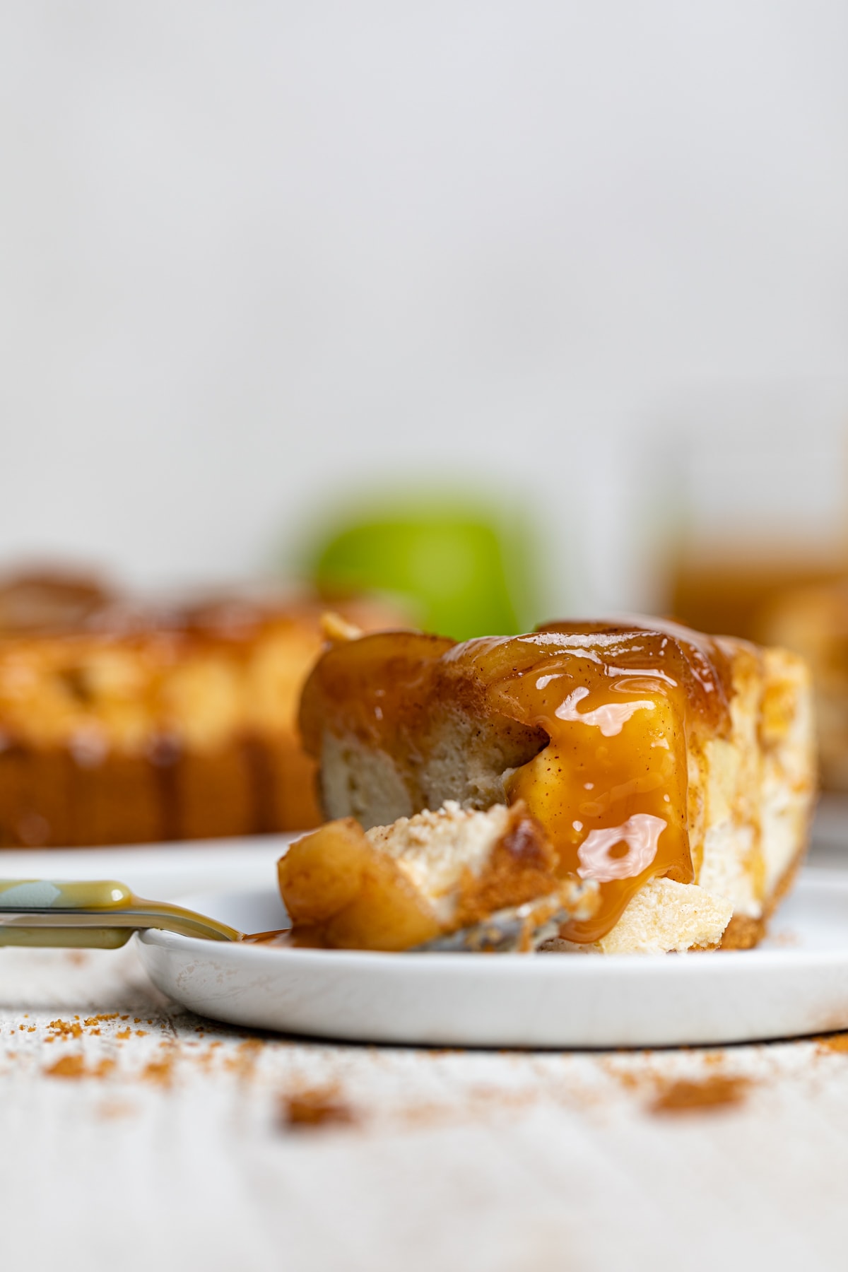 Fork grabbing a piece of Caramel Apple Spice Cheesecake.