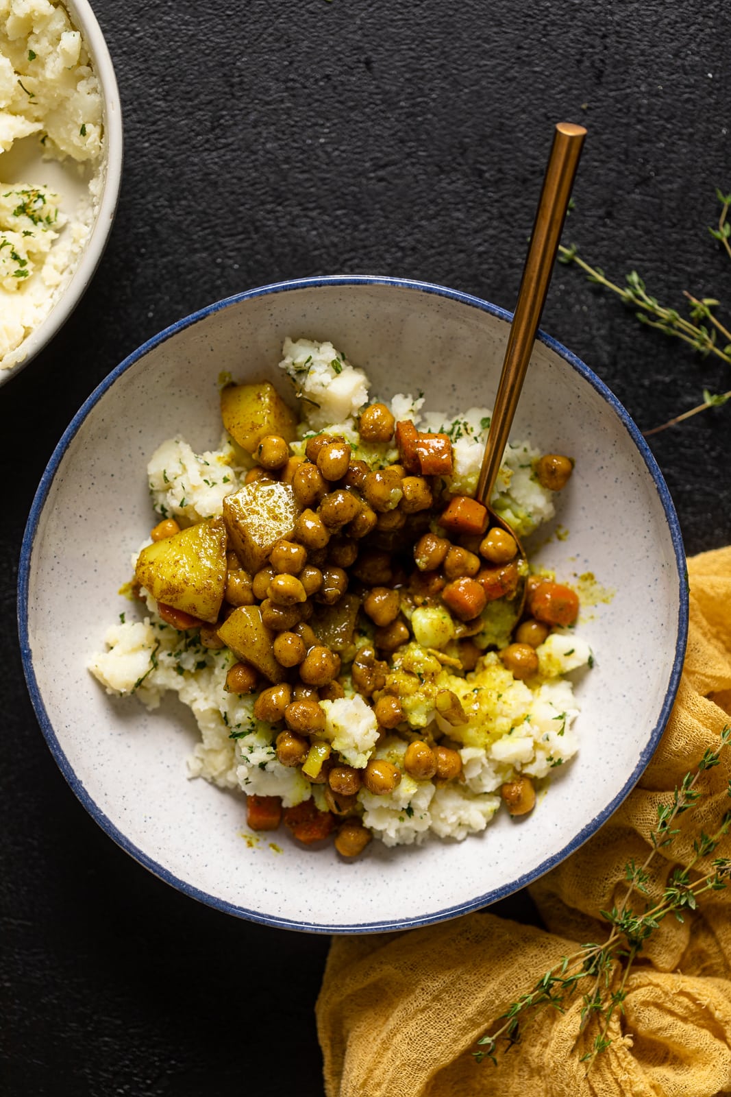 Overhead shot of a plant-based weeknight meal with Mashed Potato Bowl with a spoon