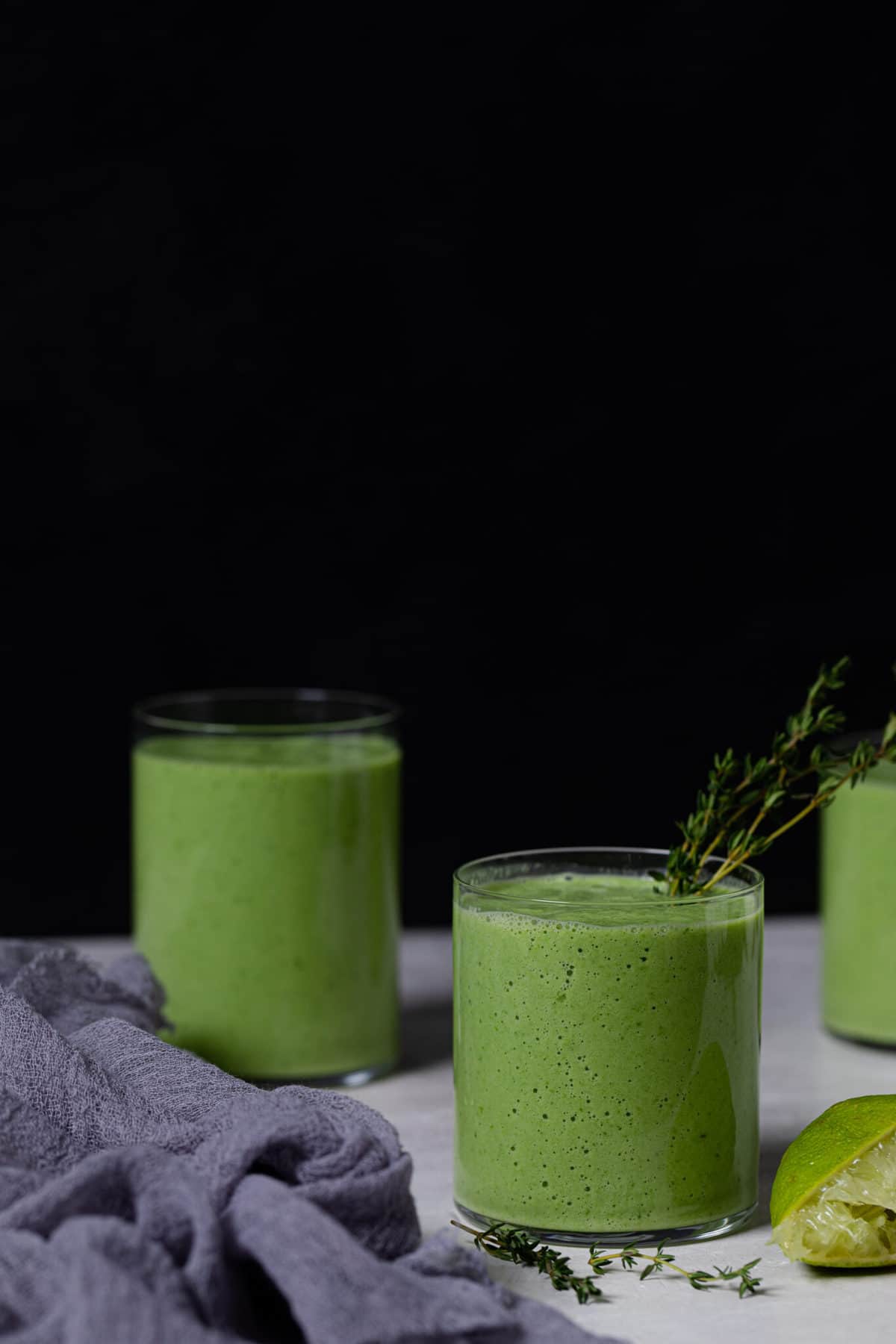 Three small glasses filled with Super Green Detox Smoothie.