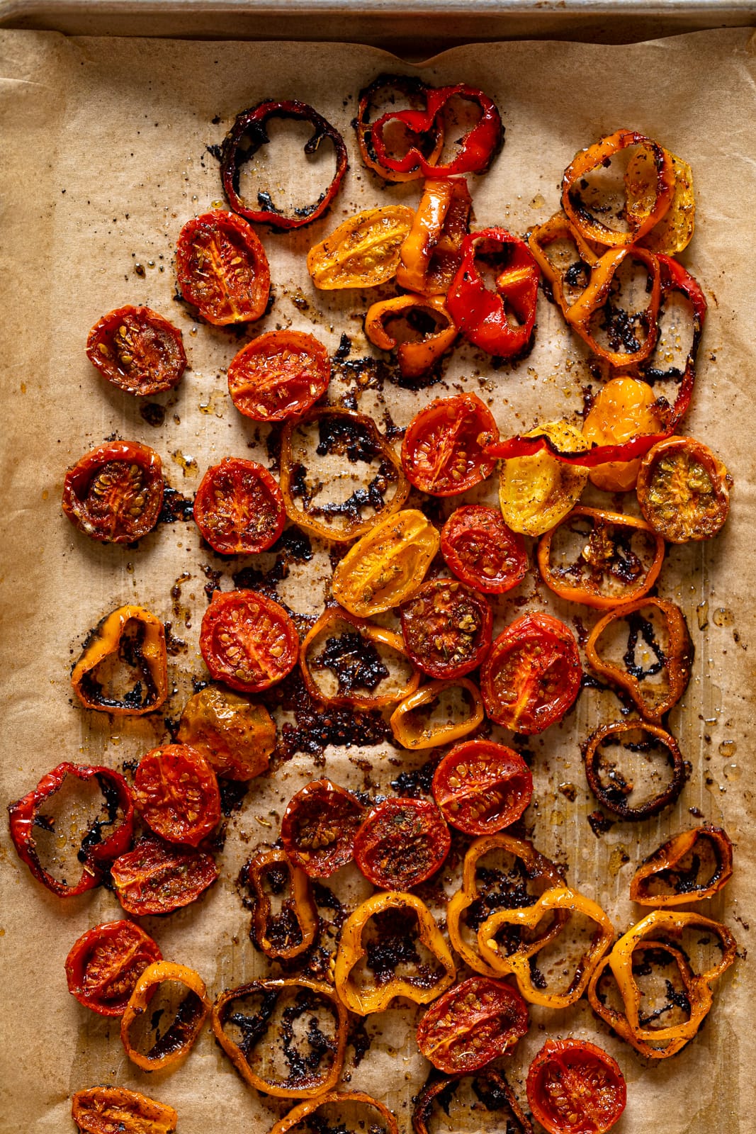 Roasted tomatoes and peppers on a sheet pan