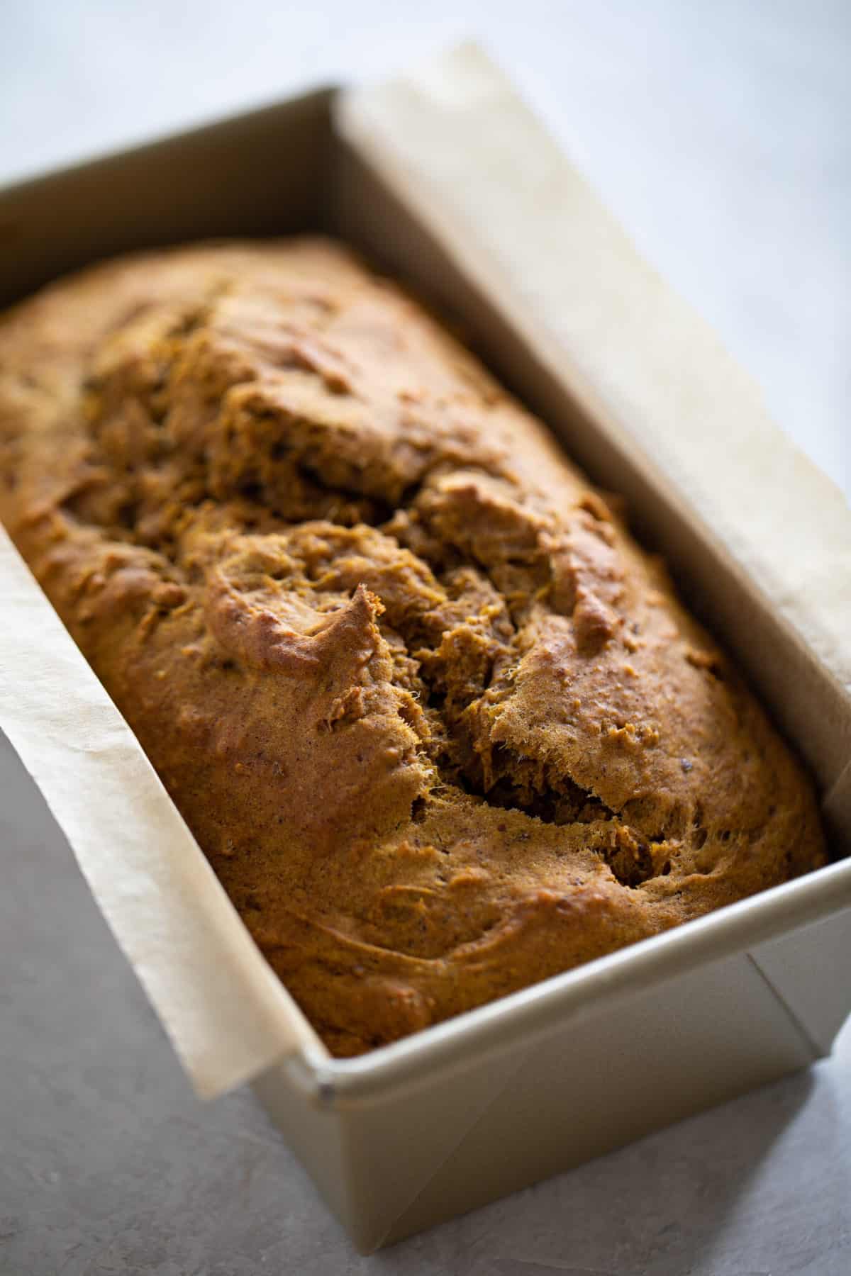 Loaf of Vegan Pumpkin Bread in a bread pan.