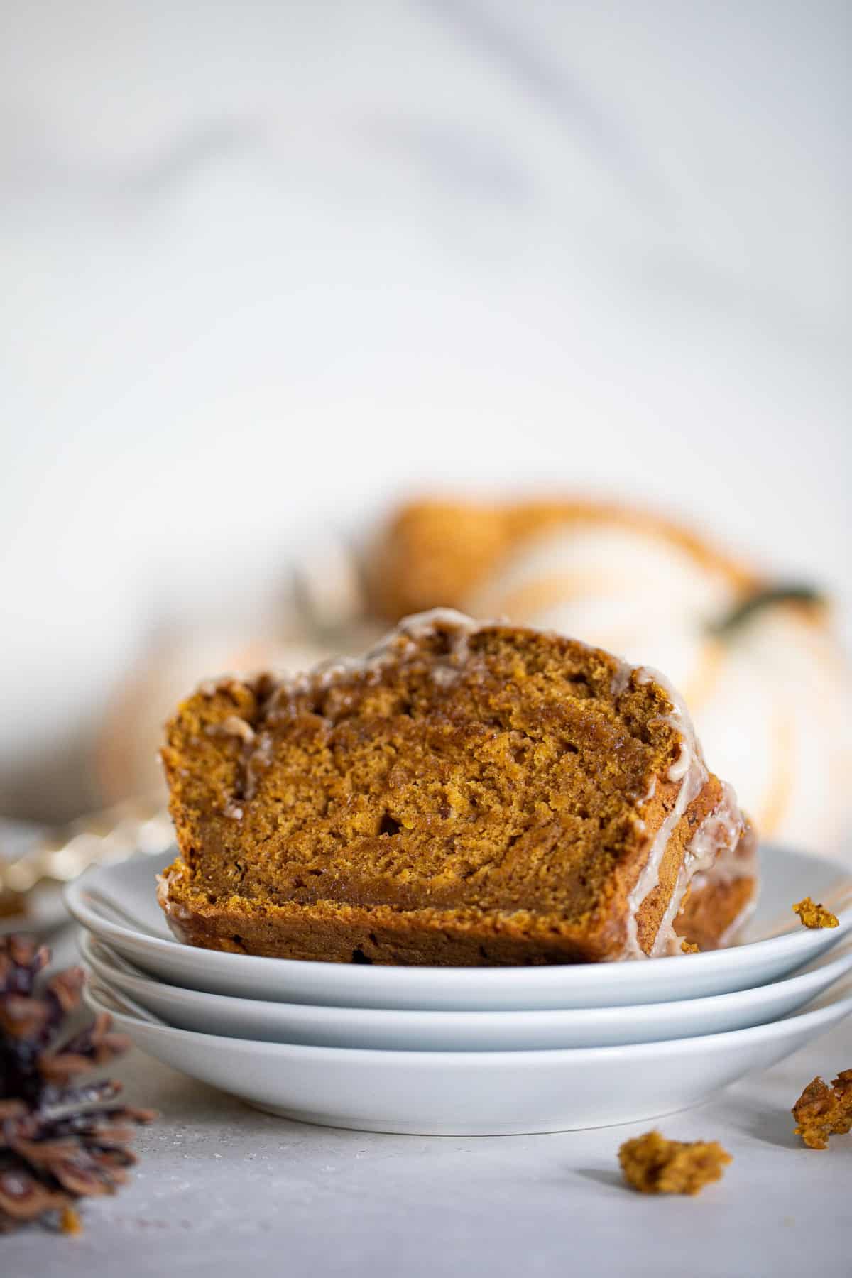 Plates topped with slices of Vegan Pumpkin Bread with Maple Chai Frosting.