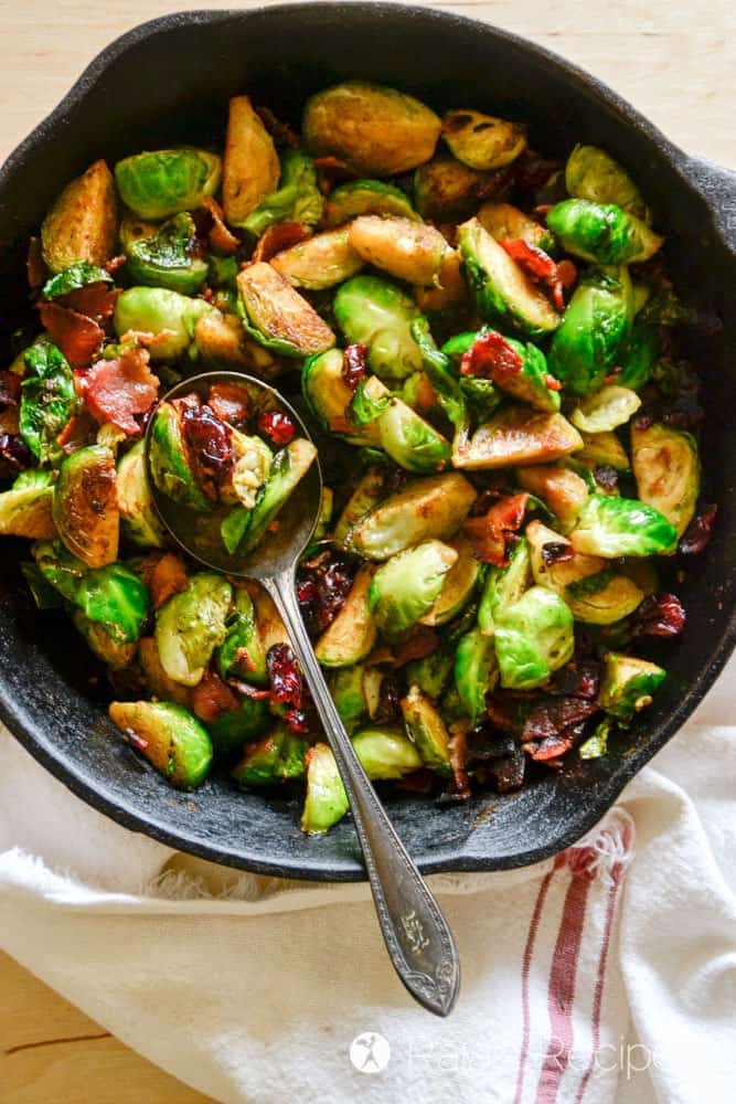 Spoon scooping brussels sprouts from a pan
