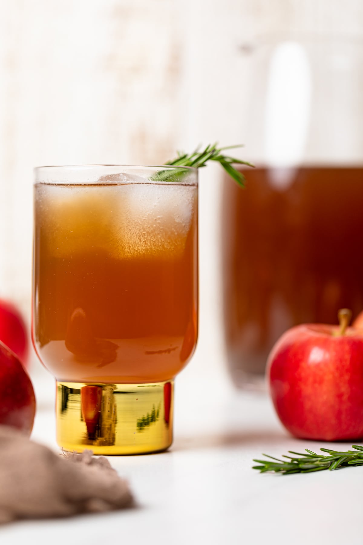 Homemade Slow Cooker Apple Cider with a sprig of rosemary.