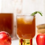 Slow Cooker Apple Cider in a small glass with a golden base.