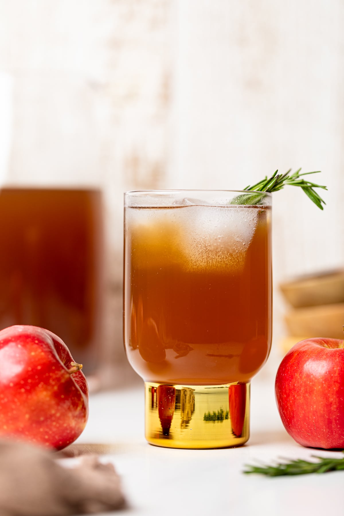 Slow Cooker Apple Cider in a small glass with a golden base