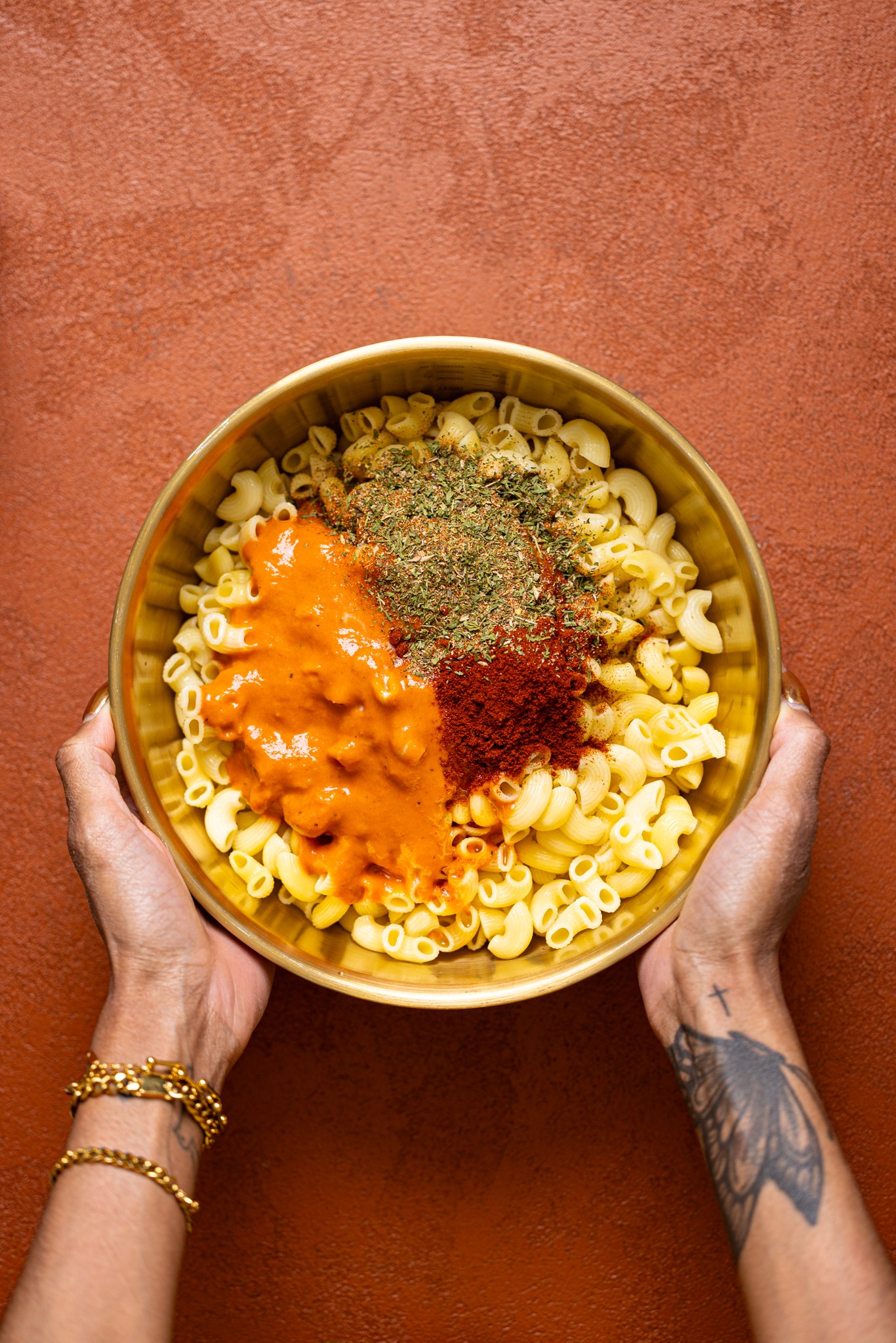 Ingredients in a bowl being held by woman hands.