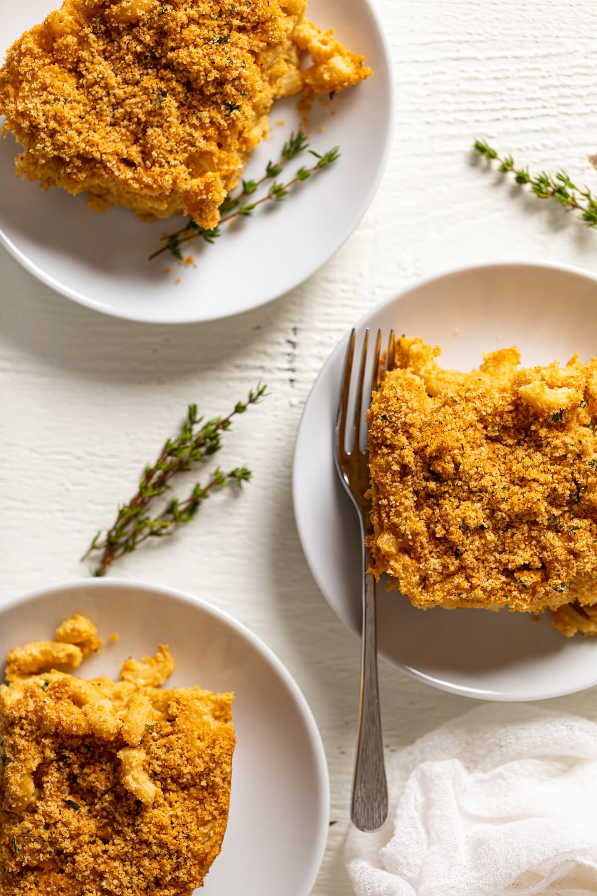 Overhead shot of plates of Baked Vegan Buffalo Mac and Cheese