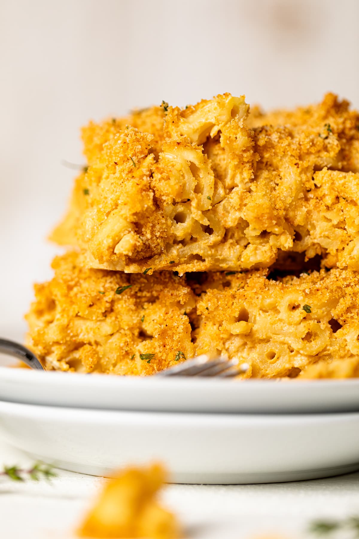 Slices of Baked Vegan Buffalo Mac and Cheese on a plate.