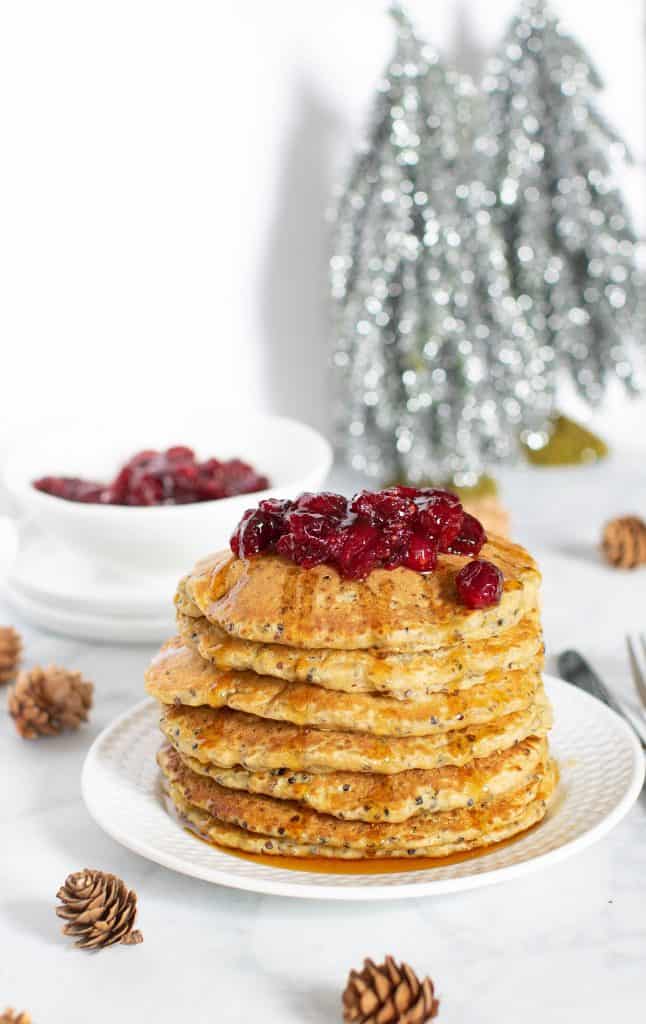 Stack of Vegan Quinoa Pancakes topped with Cranberries.