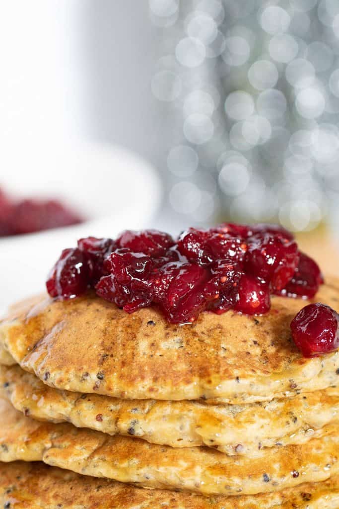 Cranberries atop a stack of Vegan Quinoa Pancakes.