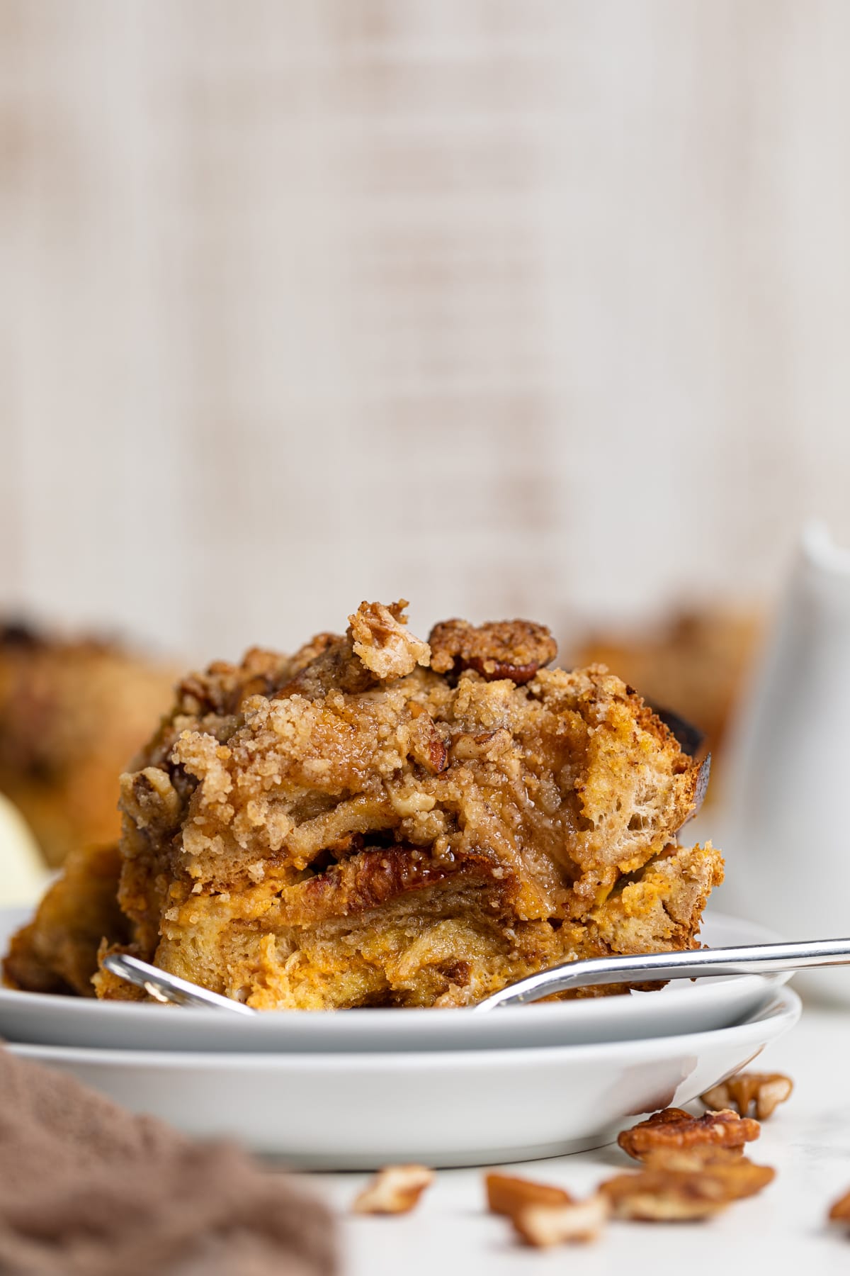 Piece of Baked Pumpkin French Toast Casserole on two small, stacked plates