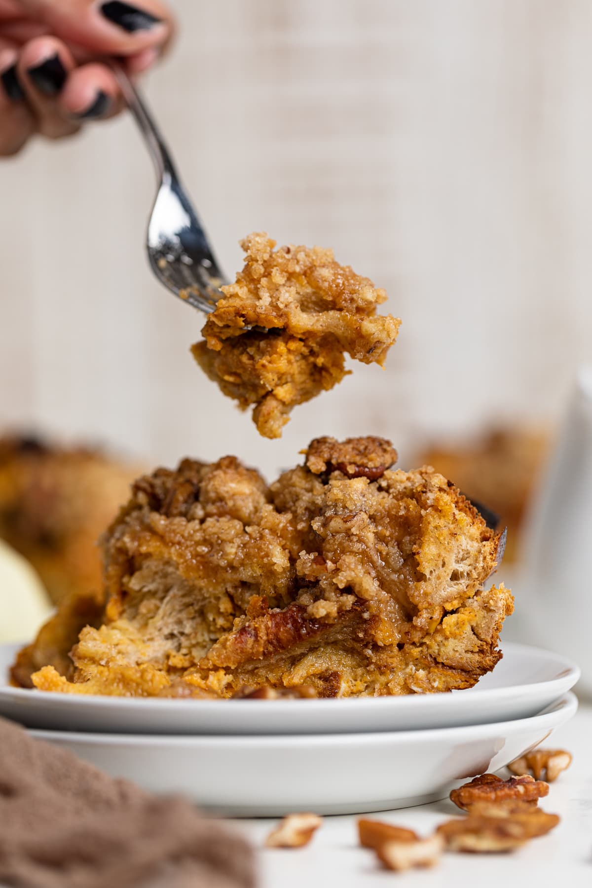 Fork grabbing a bite from a piece of Baked Pumpkin French Toast Casserole