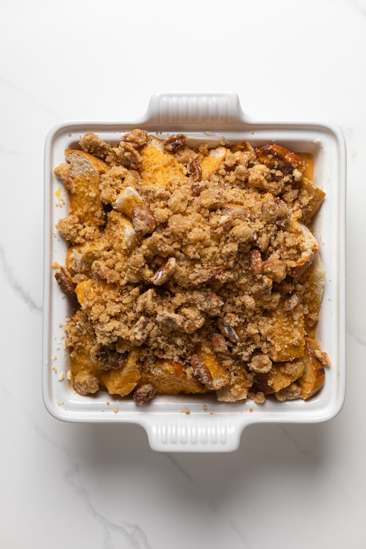 Uncooked Pumpkin French Toast Casserole in a white baking pan