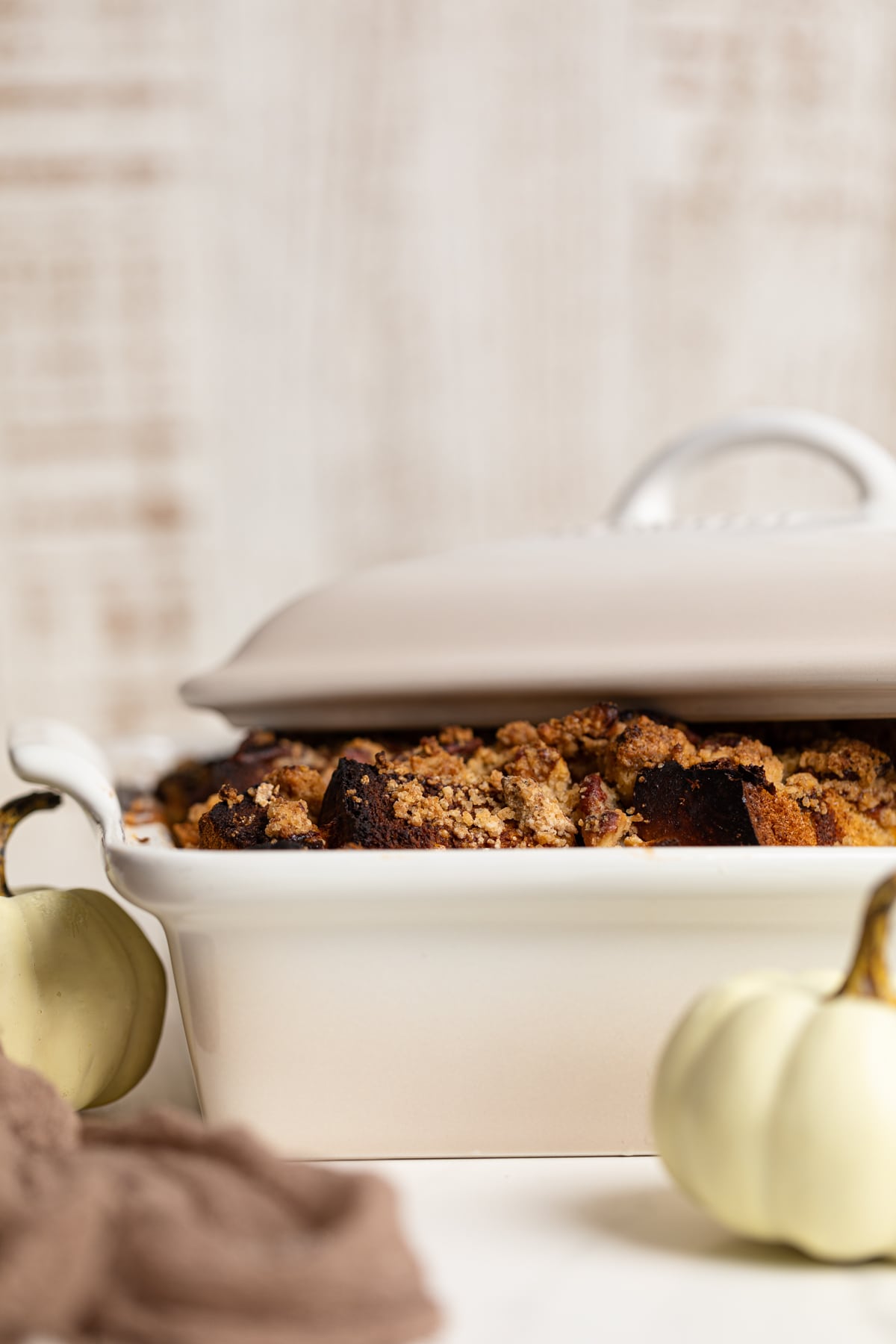 Baked Pumpkin French Toast Casserole in a baking pan with the lid half on