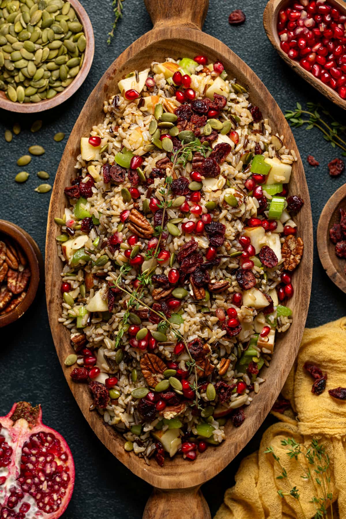 Wild rice in a serving bowl with bowl of ingredients around.