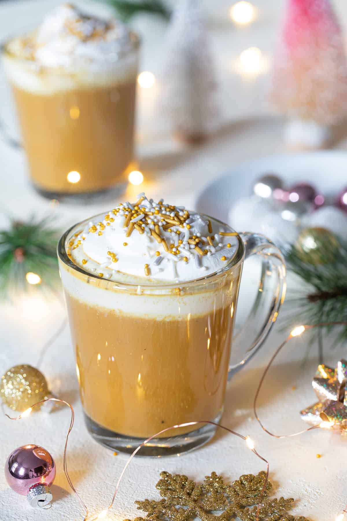 Vegan Chai Tea Latte with Turmeric topped with whipped cream and sprinkles.