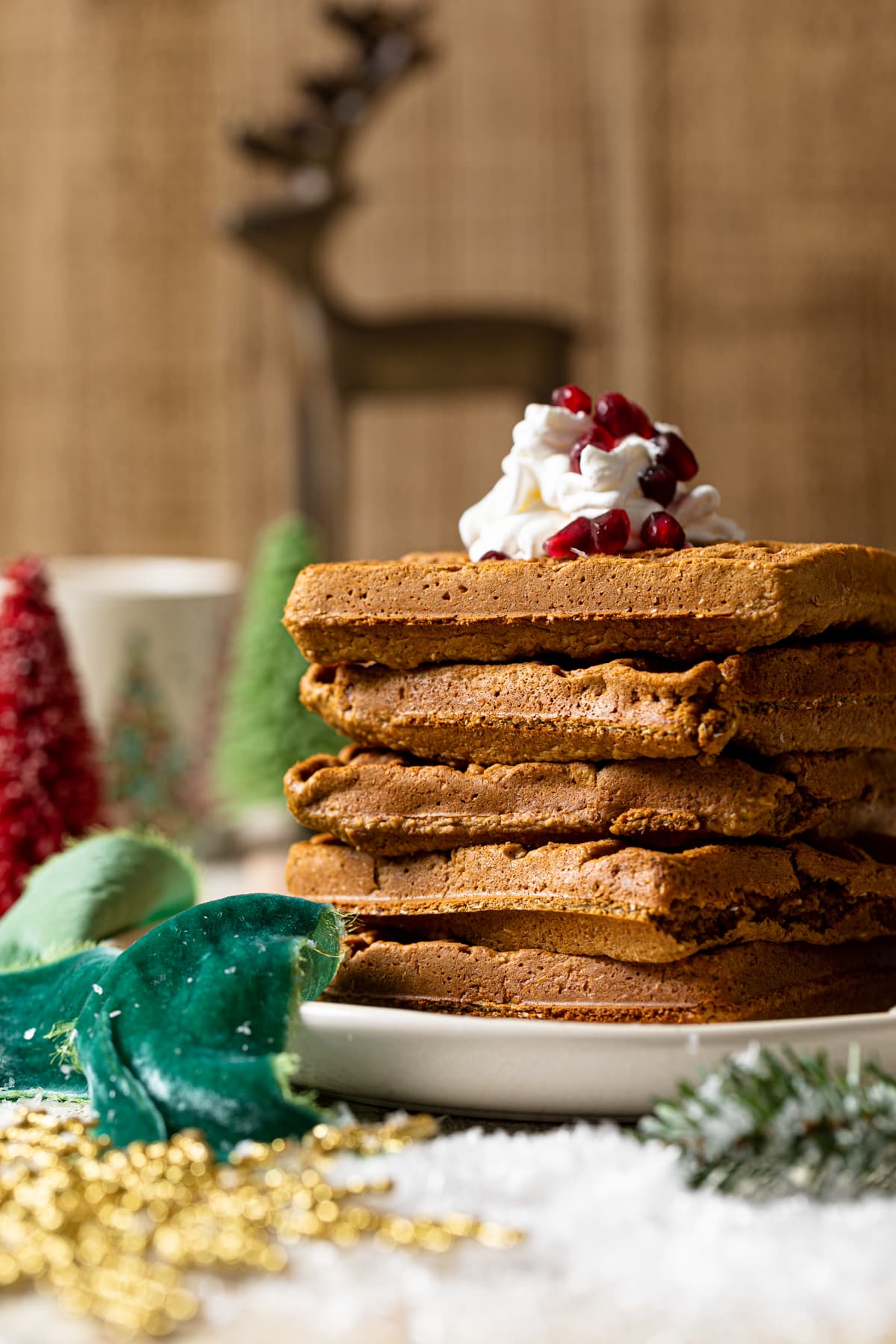 Gluten-free Flourless Gingerbread Waffles stacked on a plate.