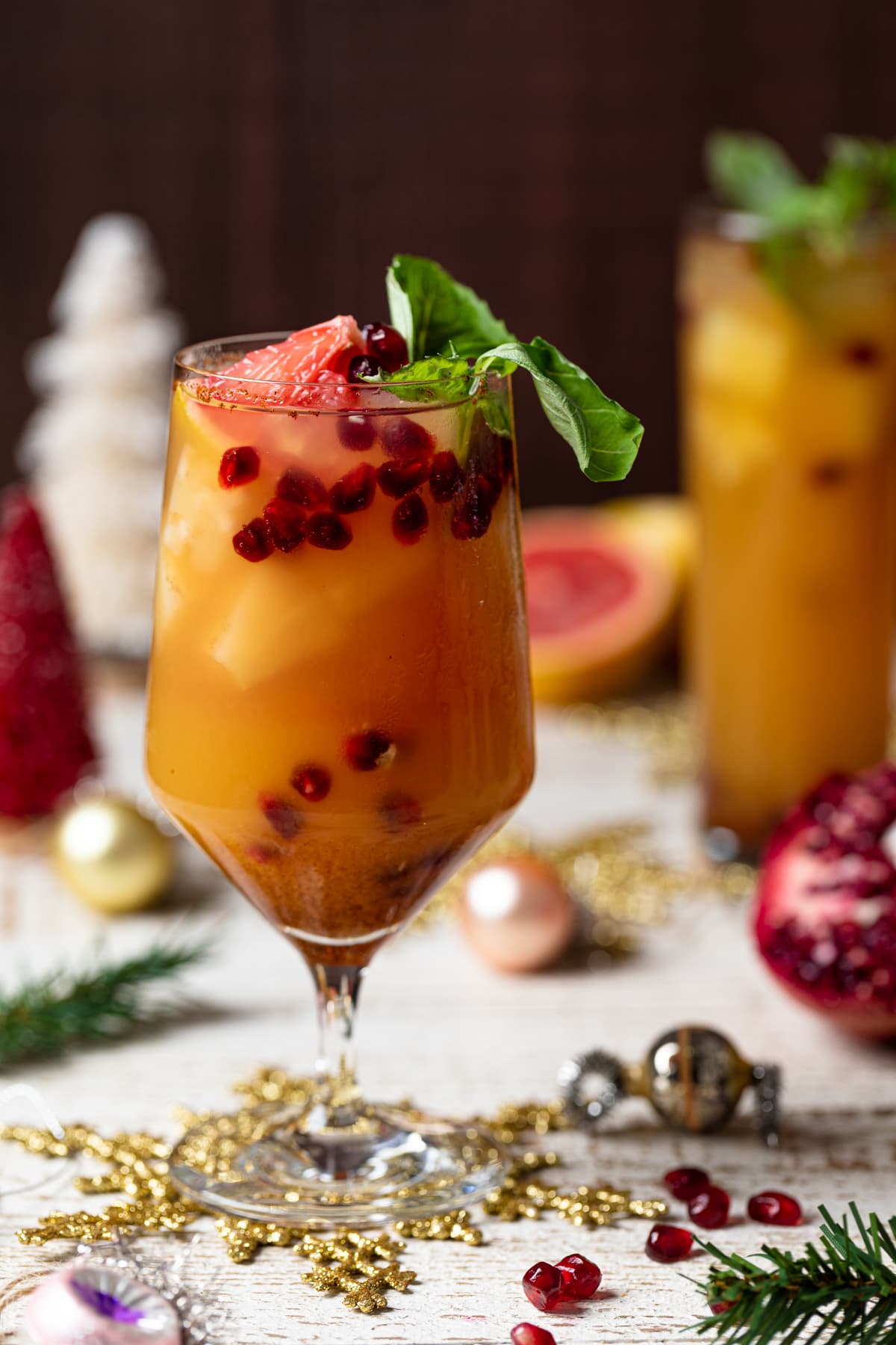 Honey Grapefruit Mocktail topped with pomegranate arils, grapefruit, and fresh basil