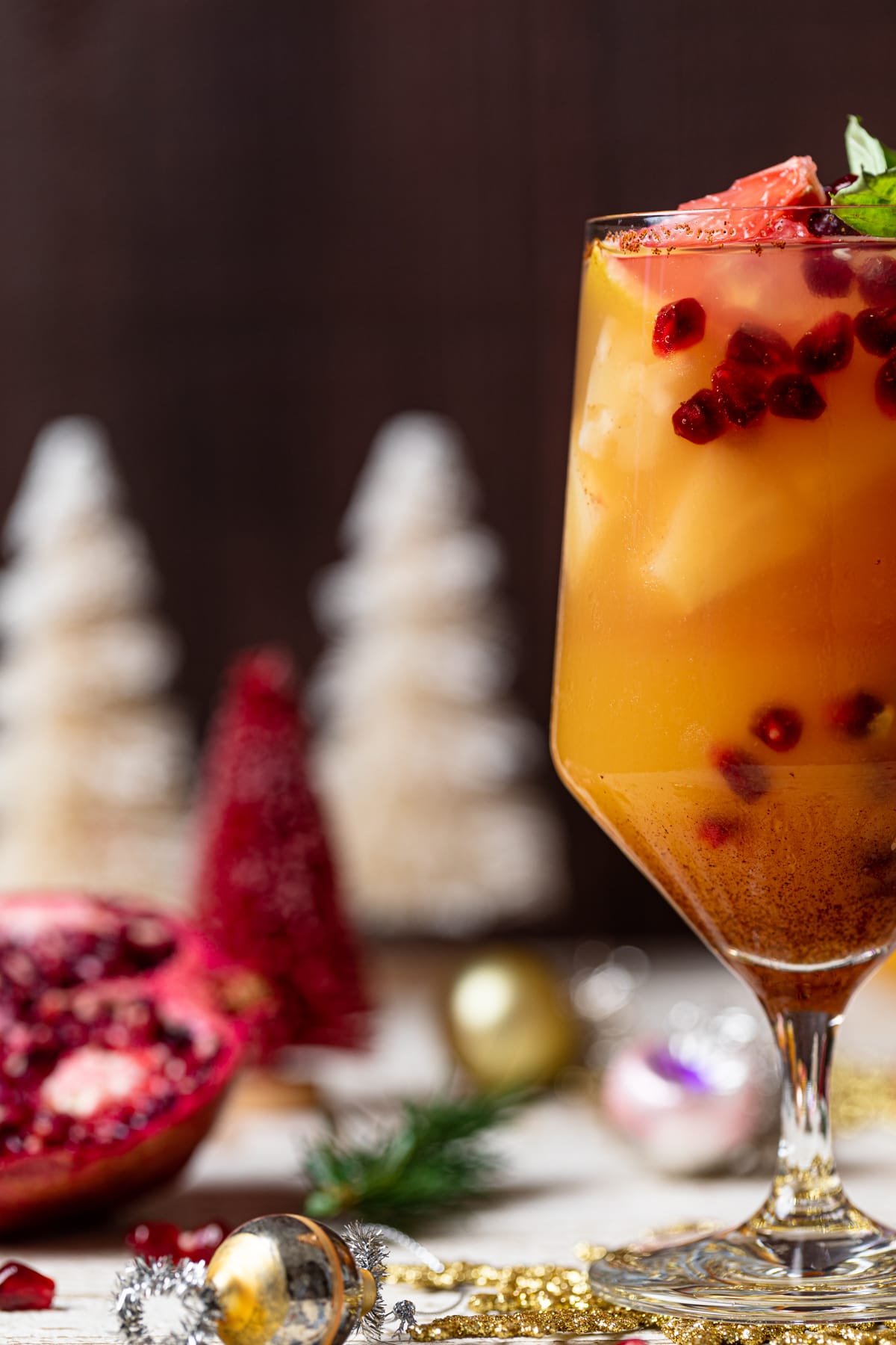 Honey Grapefruit Mocktail on a table with Christmas decorations