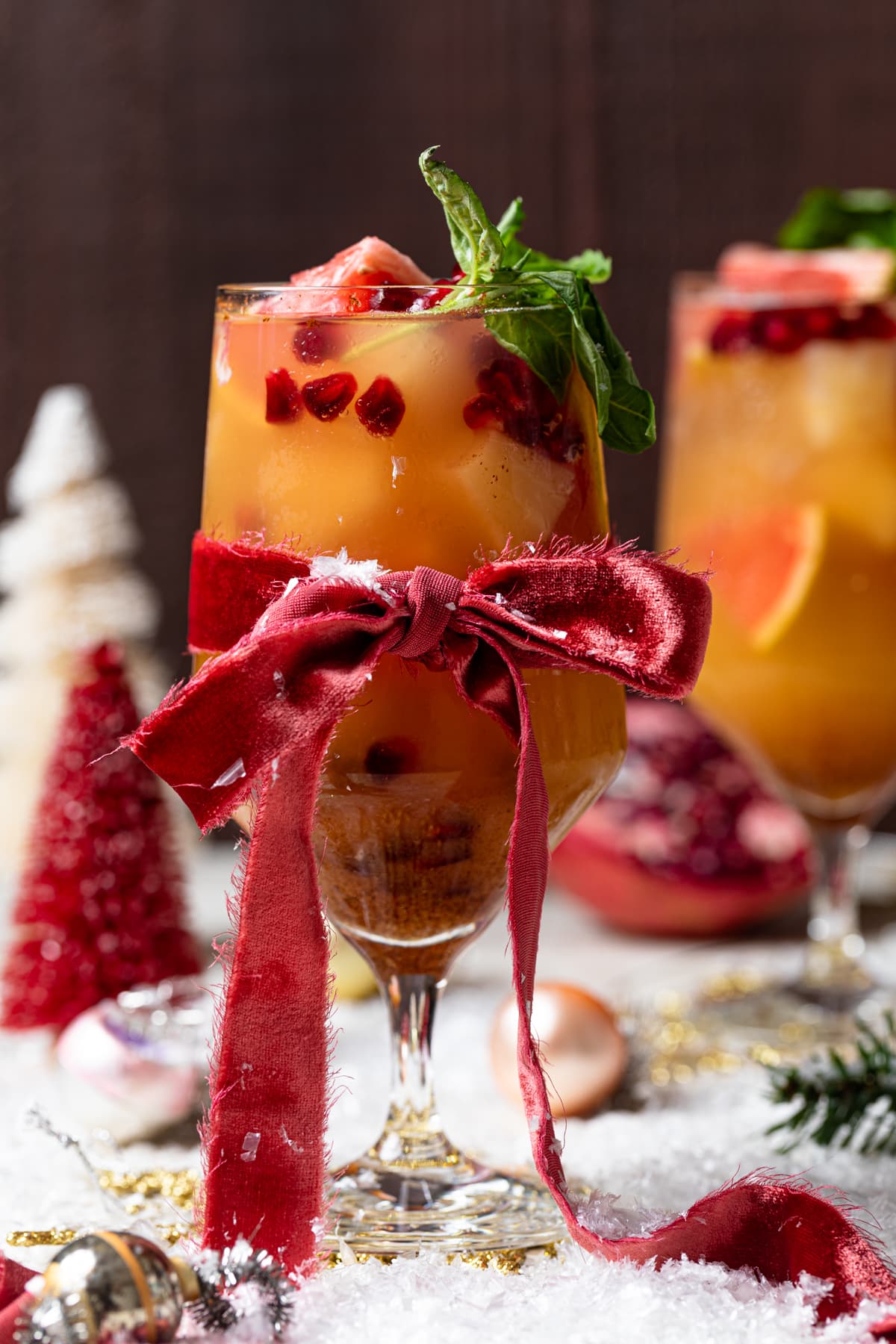 Red bow tied around a Honey Grapefruit Holiday Mocktail