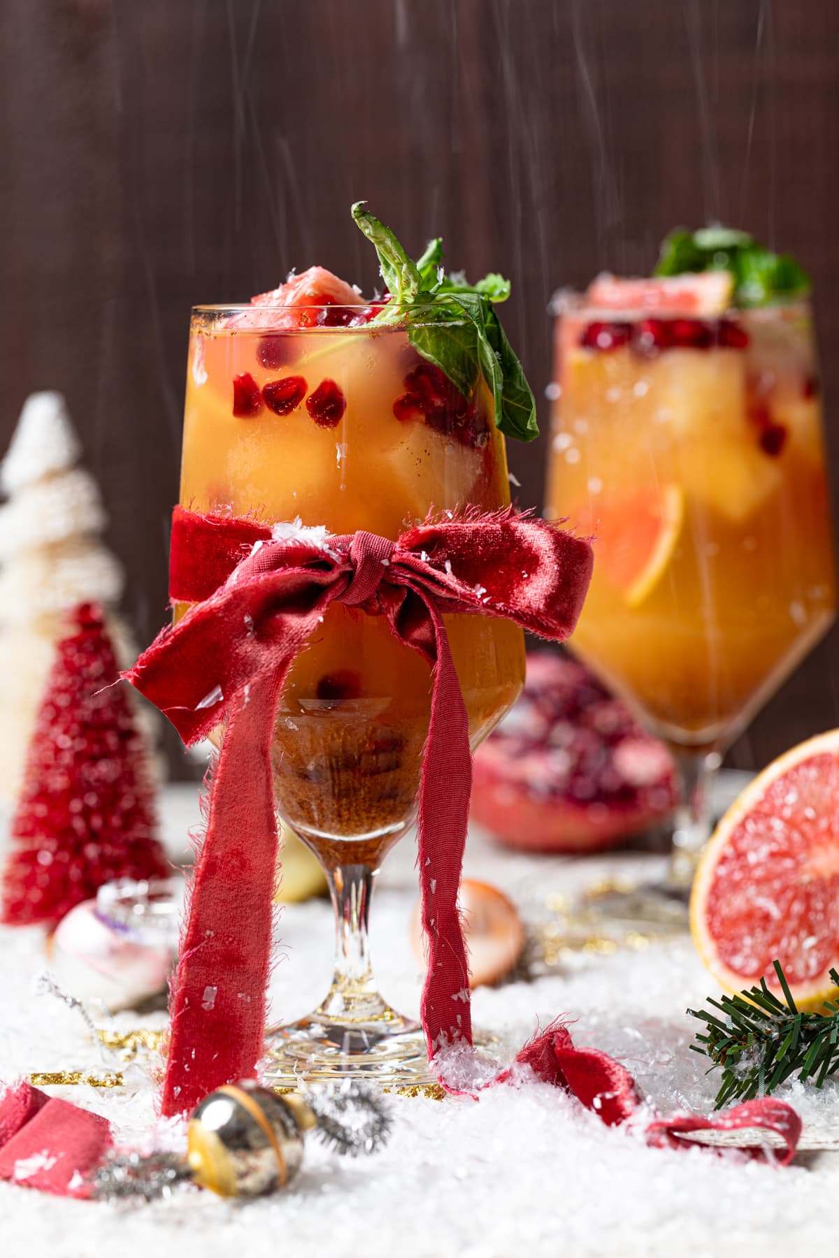 Honey Grapefruit Mocktail in a stemmed glass tied with a red ribbon