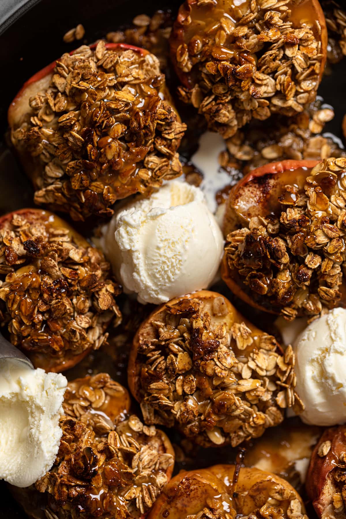 Scoops of dairy-free ice cream among Vegan Baked Cinnamon Caramel Apples.