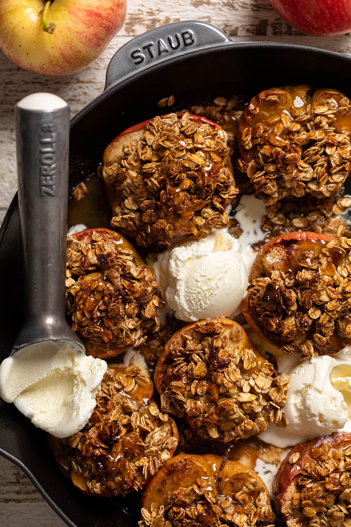 Vegan Baked Cinnamon Caramel Apples in a skillet with dairy-free ice cream.