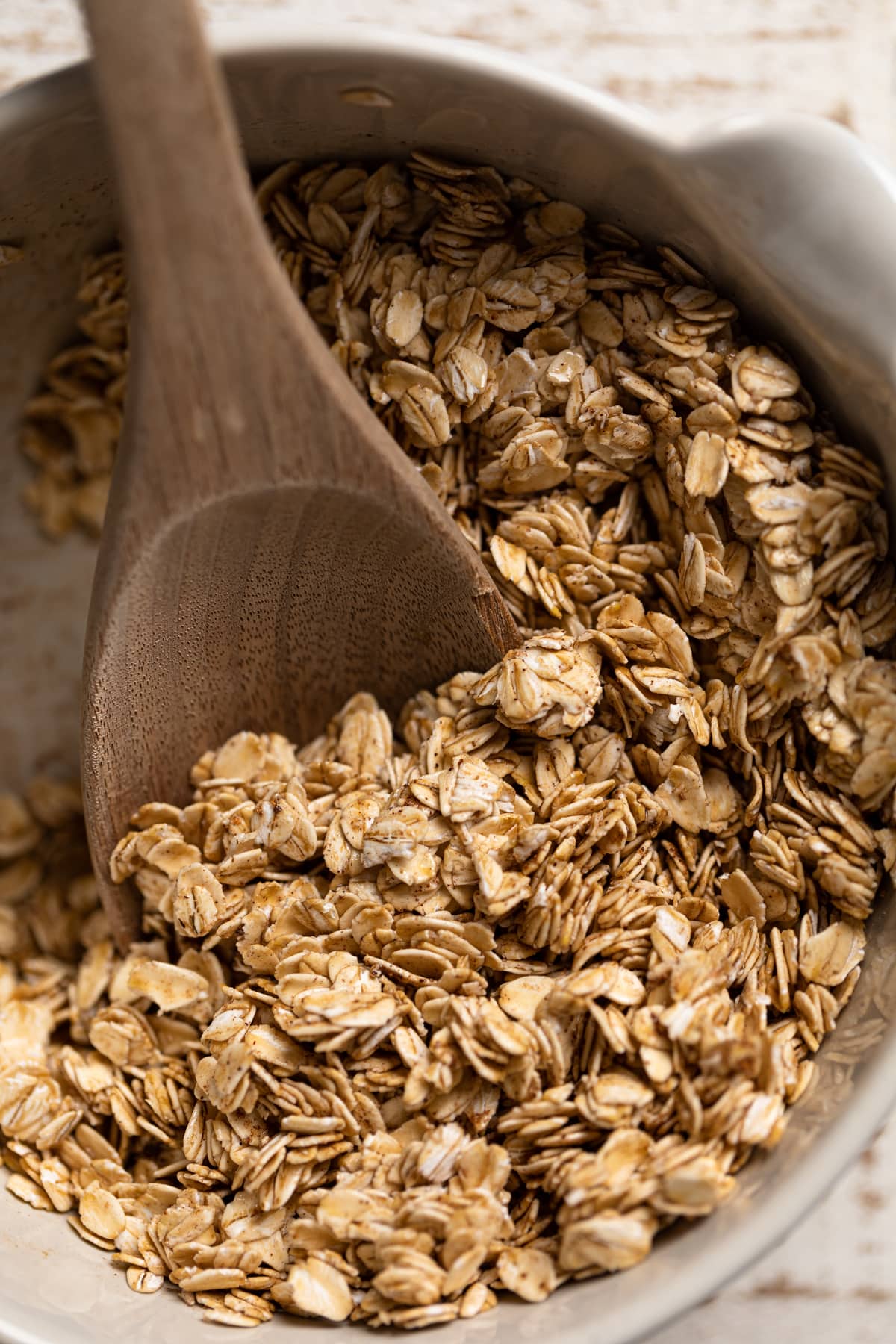 Wooden spoon scooping oats.