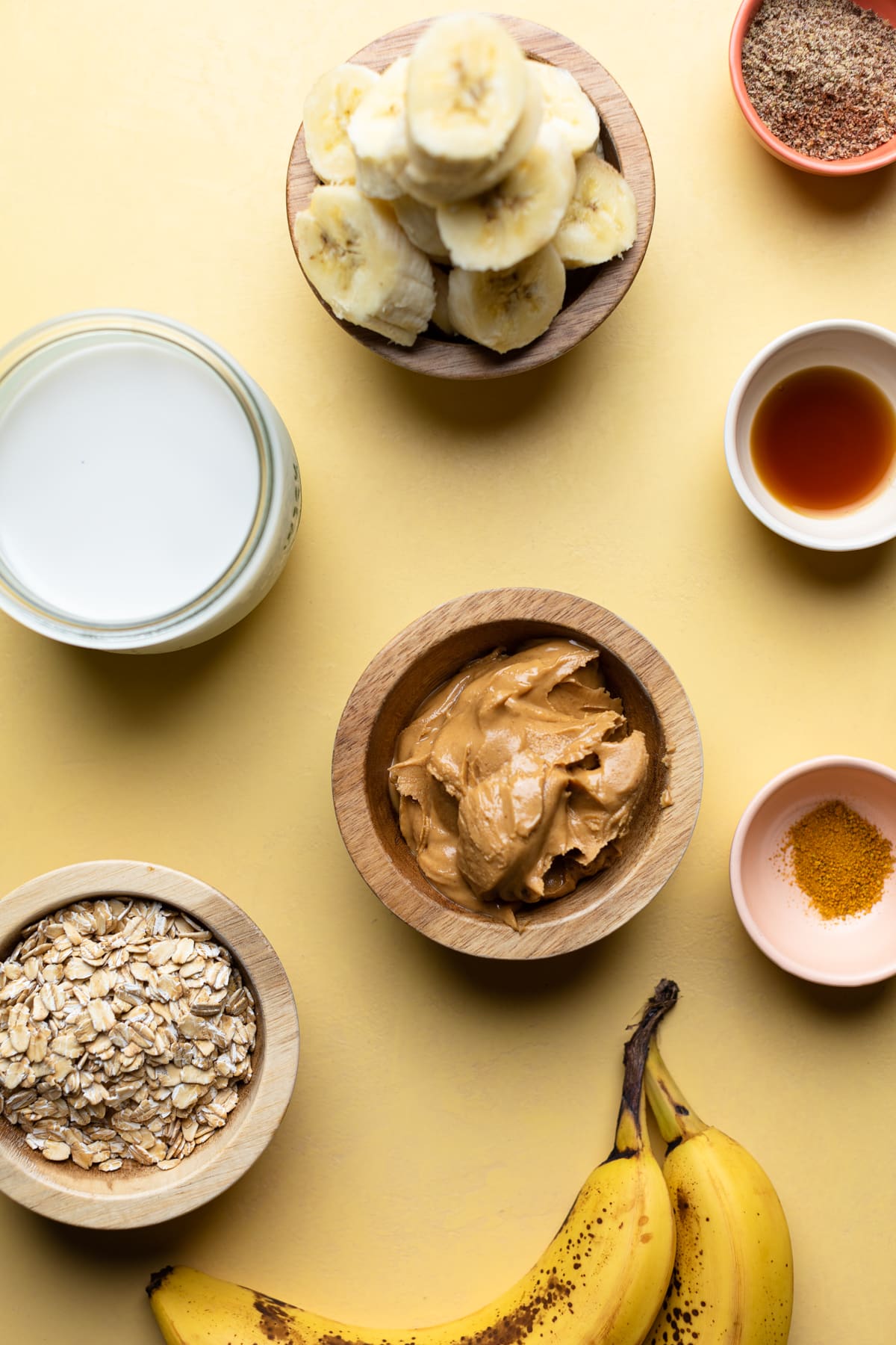 Bowls of ingredients including bananas, vanilla, and peanut butter.