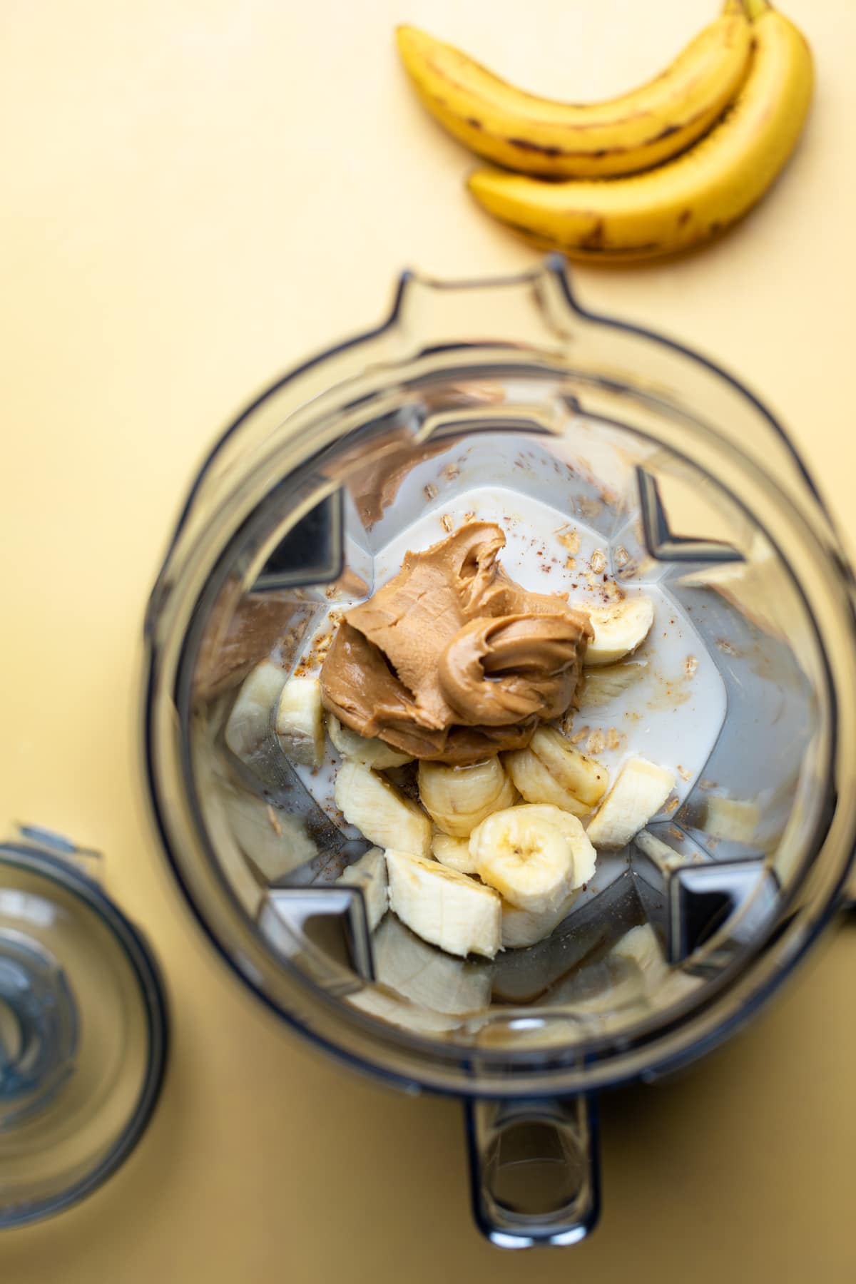 Blender of ingredients including bananas and peanut butter.
